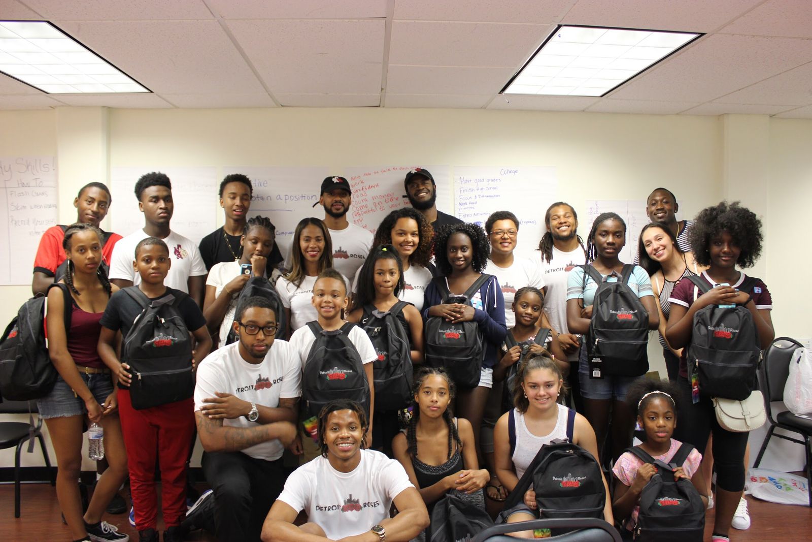 Rose Buds Youth Empowerment Program students gathered together with Detroit Roses backpacks