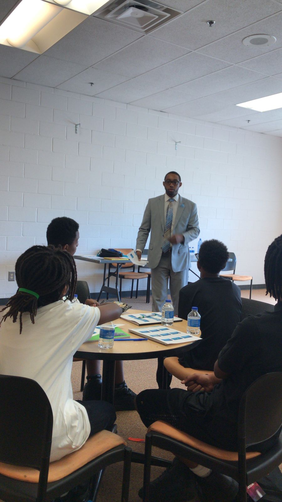 A community leader leading a Rose Buds workshop with students